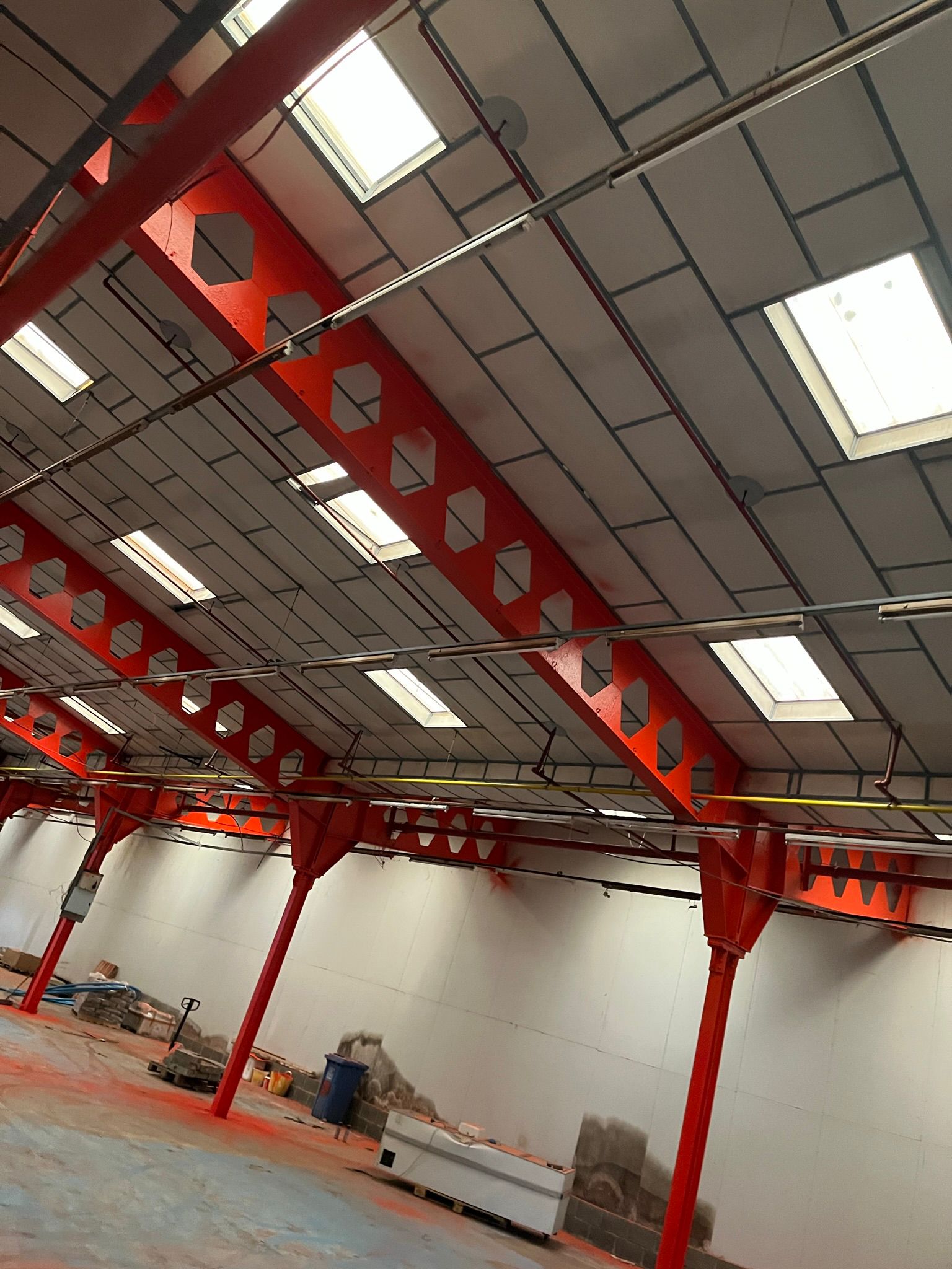 Red structural beams in industrial unit
