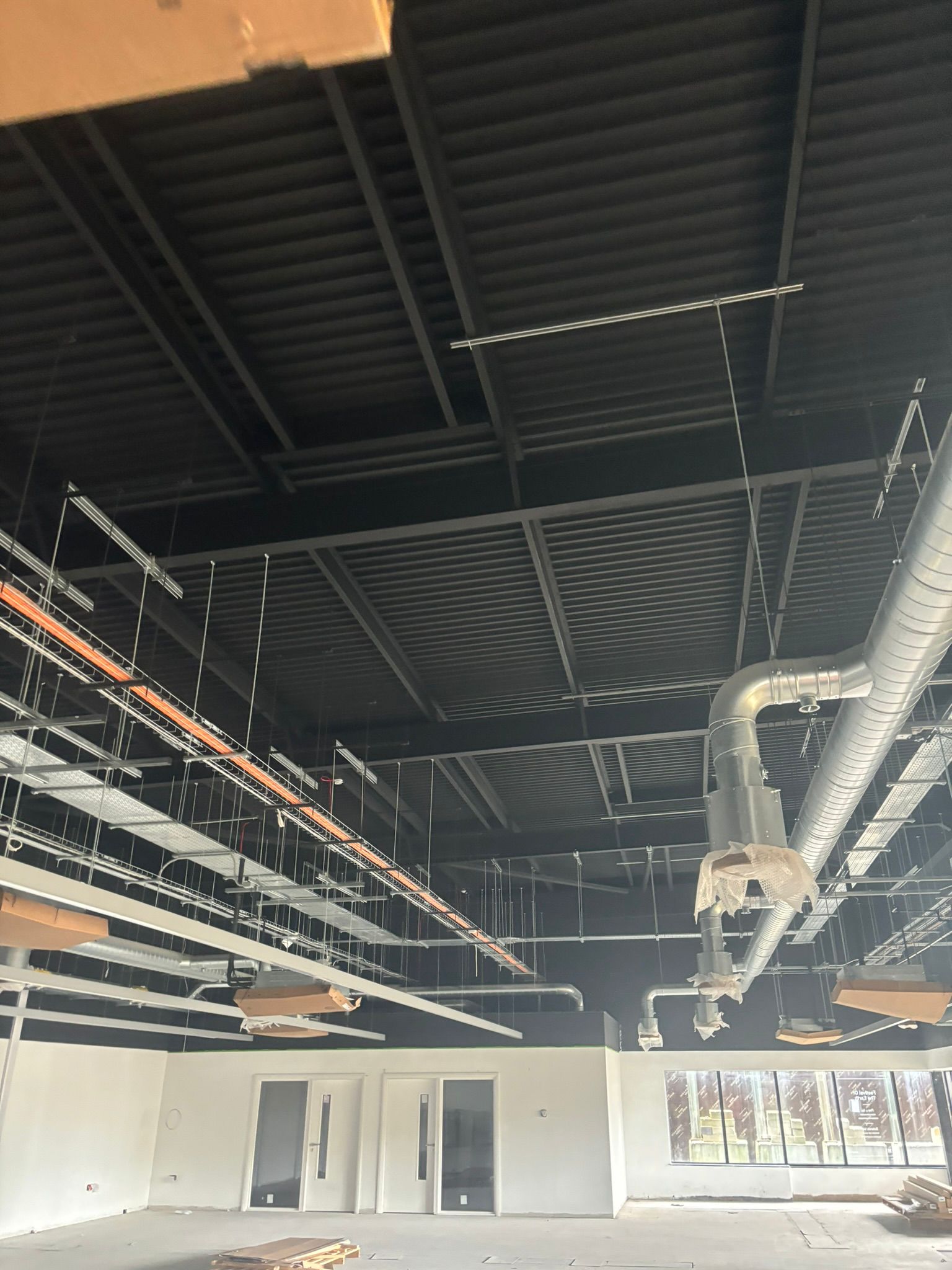 Black painted warehouse ceiling and ductwork