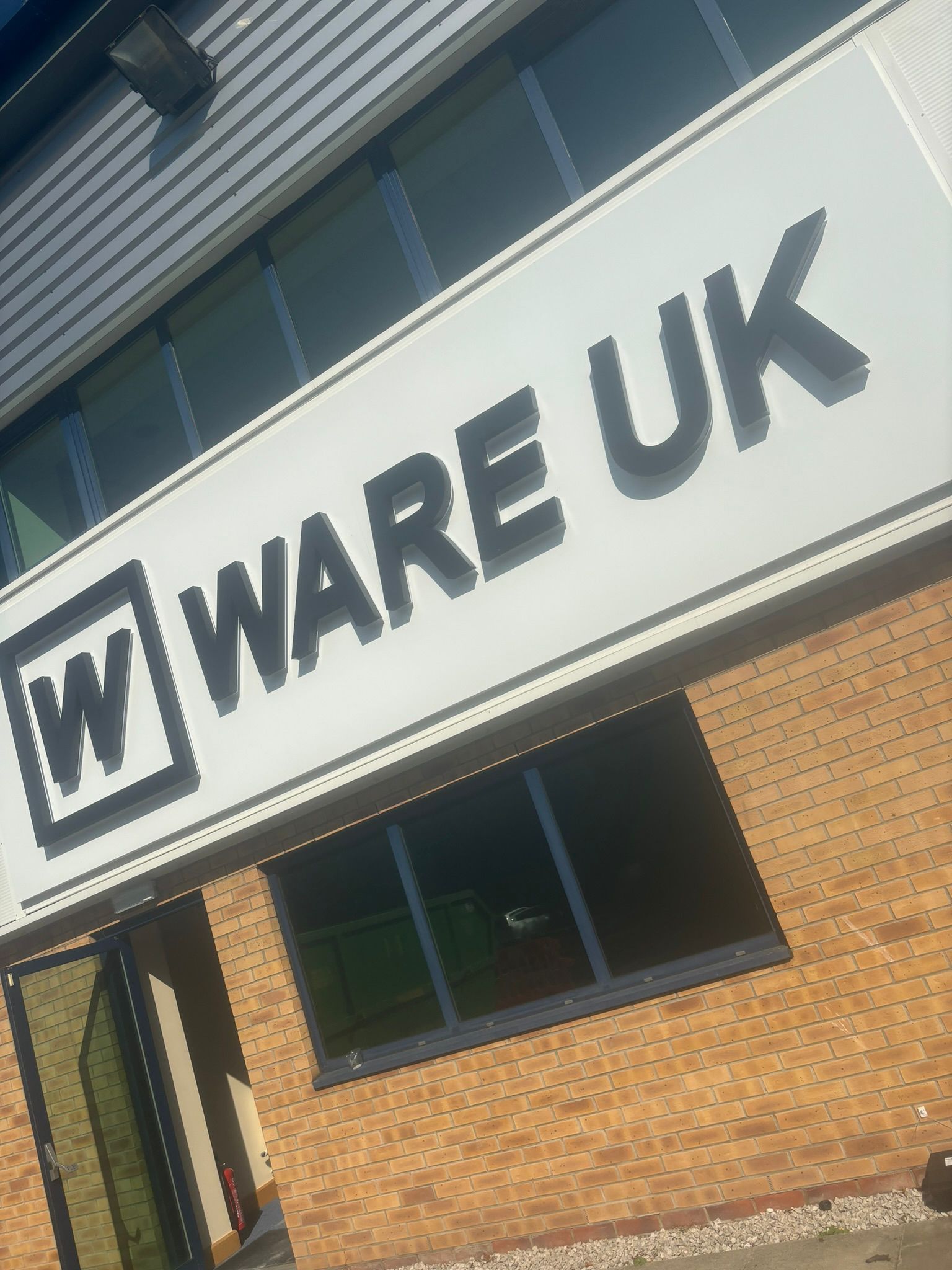 WARE UK signage with black painted aluminium framing