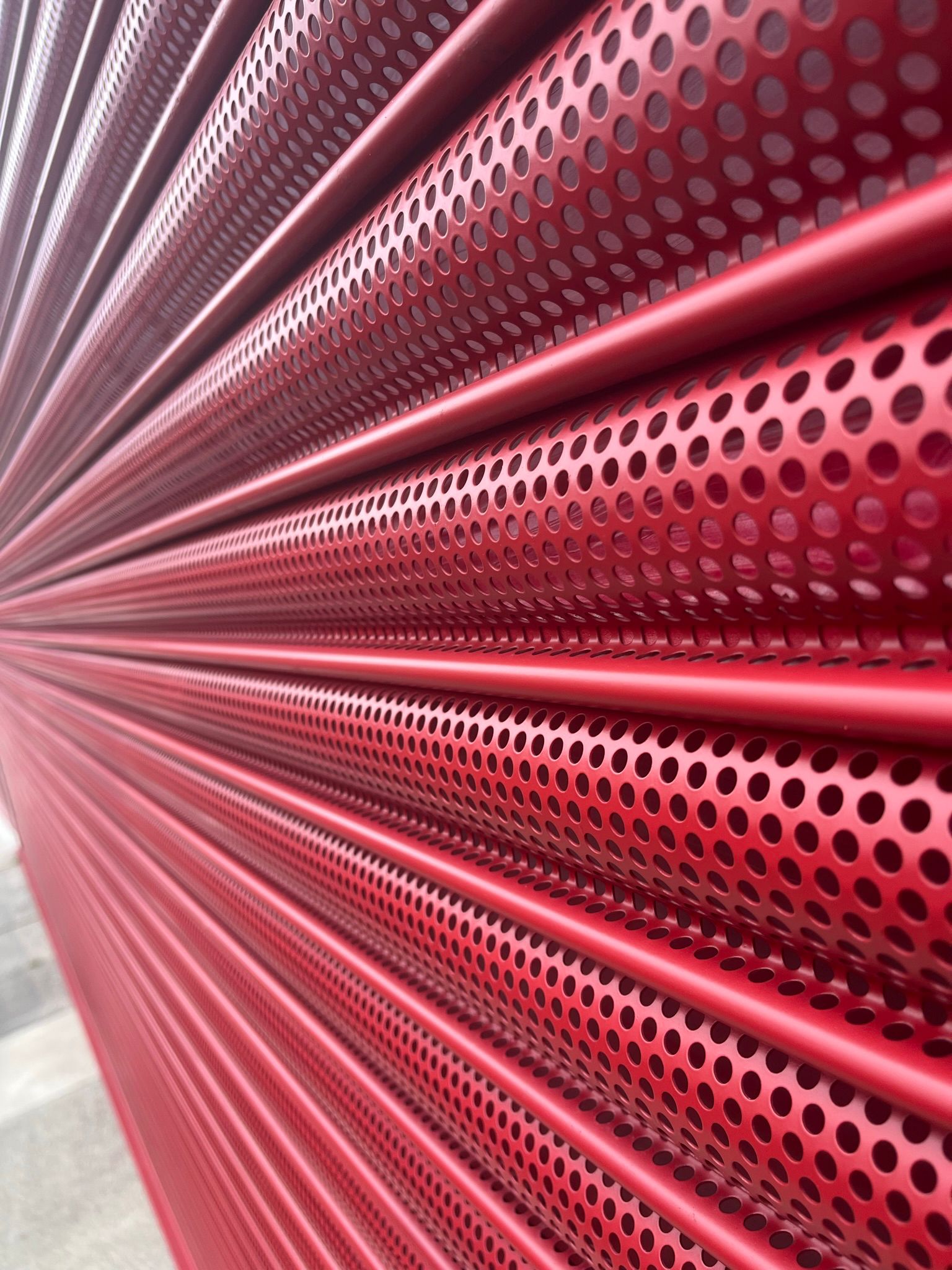 Red perforated steel cladding architectural detail