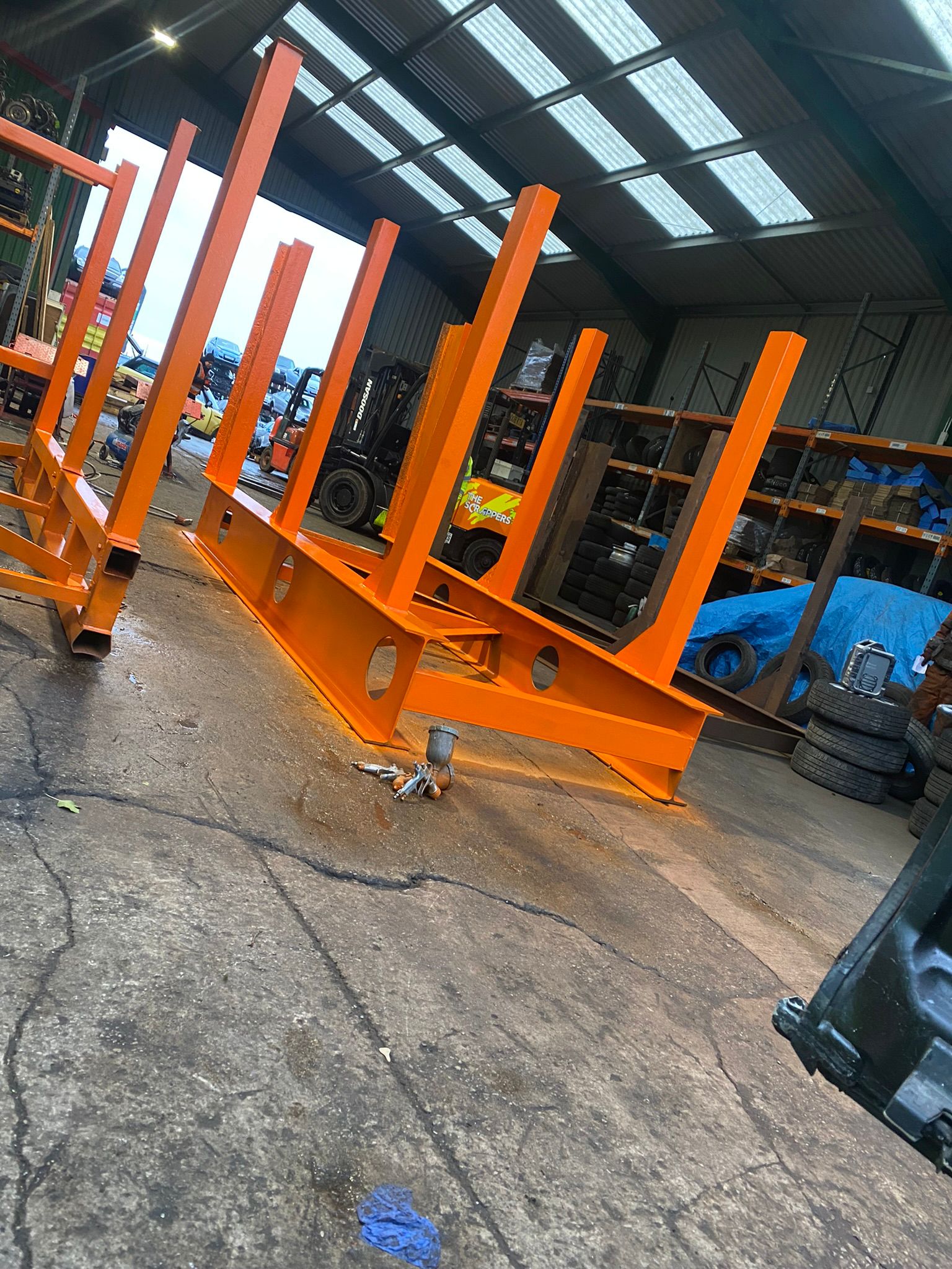 Orange painted steel frames in workshop
